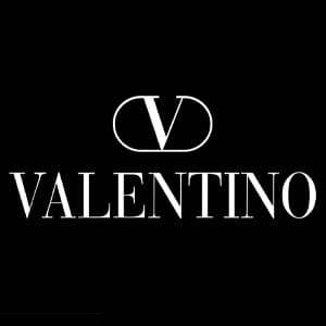 The image shows the Valentino logo with a stylized "V" above the word "VALENTINO" on a black background.